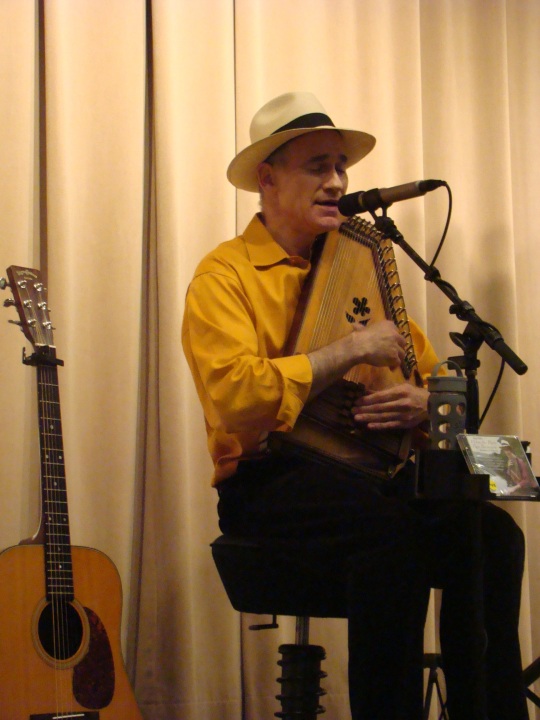 Adam Miller performs folk music using his autoharp.
